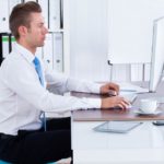 picture of a man sitting at a computer