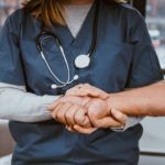 doctor helping patient