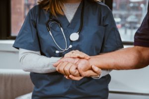 picture of a doctor helping a patient