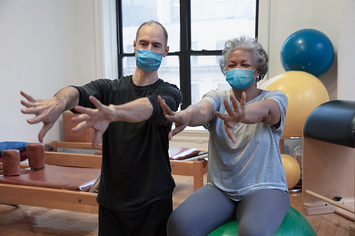 people wearing protective mask person instructing a woman