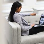 woman with laptop on couch