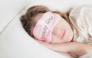 woman in beauty rest mask in pillow