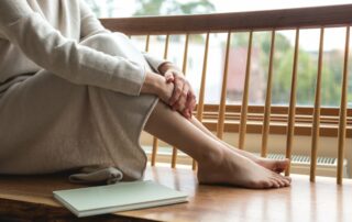 woman resting her feet by the window