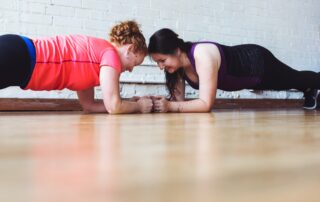 women who plank together