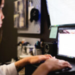woman-works-on-bright-computer-screens bad posture with 2 screens