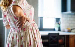 Woman experiencing back pian