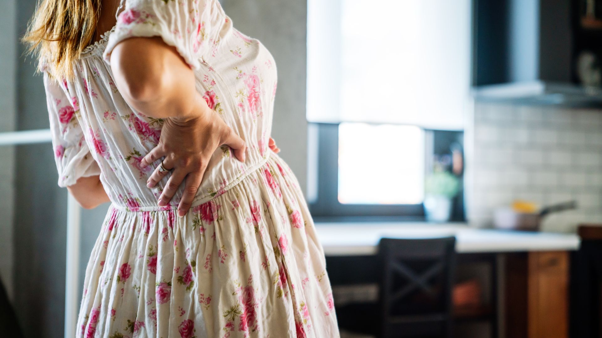 Woman experiencing back pian