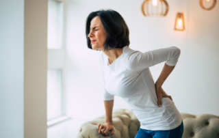 A woman experiencing backpain after giving birth