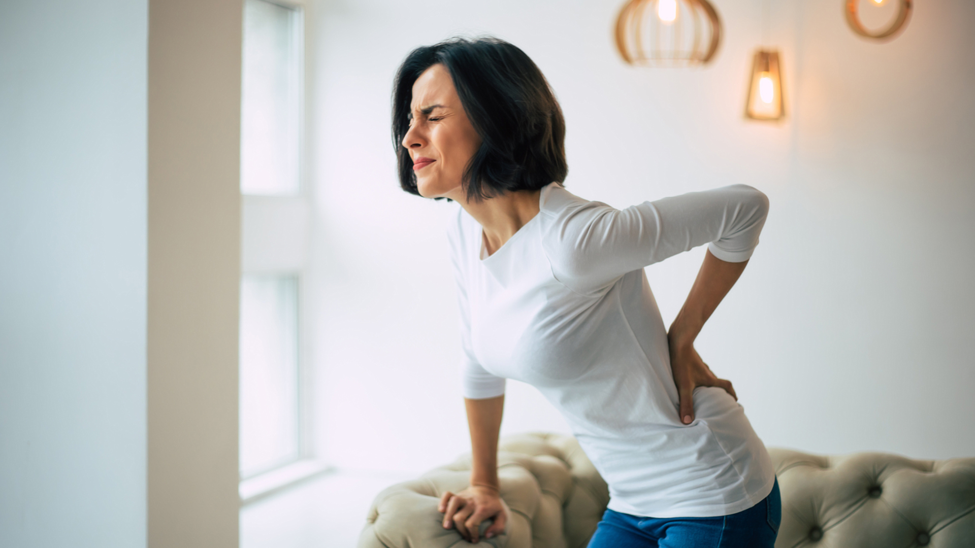 A woman experiencing backpain after giving birth