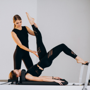 Woman doing pilates with an instructor